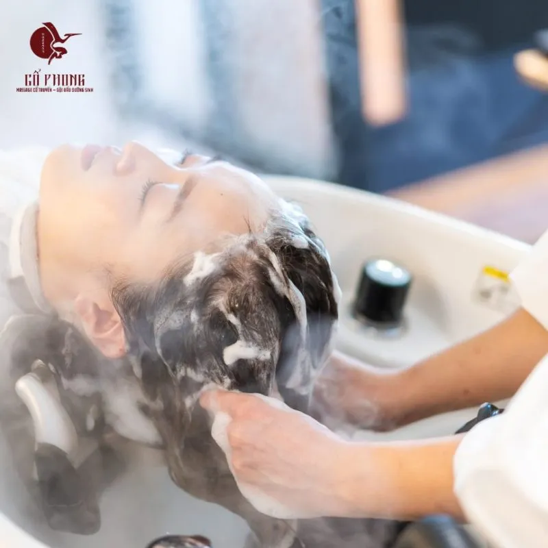Unwinding during the herbal hair wash at Massage Cổ Phong